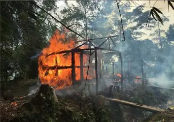  ?? Associated Press ?? Houses burn on Sept. 7, 2017, in Gawdu Zara village, Myanmar. Journalist­s said fires burned in the village that had been abandoned by Rohingya Muslims and where pages from Islamic texts were seen ripped and left on the ground.