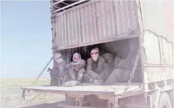  ?? — AFP ?? IS group’s fighters and their families sit in the back of a truck as they leave IS’S last holdout of Baghouz in Syria’s northern Deir Ezzor province on Wednesday.