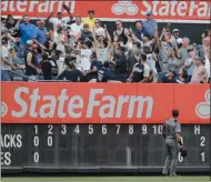  ?? FRANK FRANKLIN II — THE ASSOCIATED PRESS ?? Arizona Diamondbac­ks left fielder David Peralta watches as fans fight for a ball hit by New York Yankees’ Mike Tauchman for a two-run home run during the second inning of a baseball game Wednesday, July 31, 2019, in NewYork.