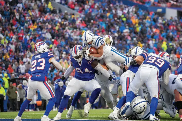  ?? JEFF LEWIS / ASSOCIATED PRESS ?? Indianapol­is Colts running back Jonathan Taylor (28) leaps into the end zone for one of his five touchdowns Nov. 21 against the Buffalo Bills in Orchard Park, N.Y. The Colts won the game, 41-15, improving to 6-5 on the year, while the Bills dropped out of first place in the AFC East division, falling to 6-4.