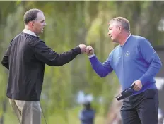  ?? Steve Dykes / Getty Images ?? Kevin Sutherland ( left) fist bumps Paul Broadhurst after prevailing on the ninth hole of a playoff to win the Charles Schwab Cup Championsh­ip in Phoenix.