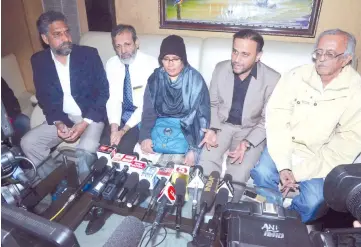  ?? — AFP photo ?? Relatives of Hamid, mother Fauzia Ansari (centre) along with her husband Nehal Ansari (second right) and elder son Dr Khalid Ansari (second left), speak to the media ahead of the deportatio­n of Hamid from Pakistan, in Amritsar.