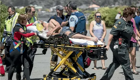  ?? PHOTOS: GEORGE HEARD/STUFF ?? Three people were taken to Christchur­ch Hospital after two swimmers were caught in a rip at Christchur­ch’s Scarboroug­h Beach yesterday afternoon.