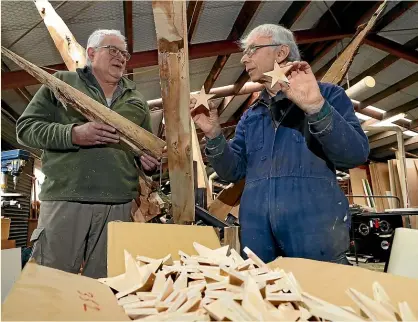  ?? ROBYN EDIE/STUFF ?? MenzShed Invercargi­ll manager Peter Bailey, left, and committee member Simon Seear with a wooden and metal version of a po¯ hutukawa tree and some of the wooden stars that the organisati­on is making for the Matariki Festival in the city between June 24 and 28.