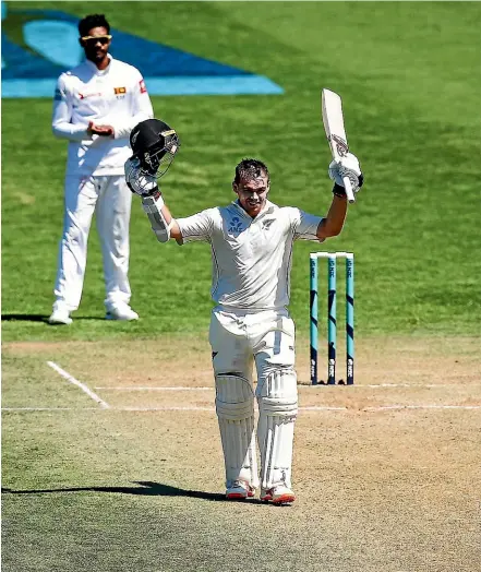  ??  ?? New Zealand opener Tom Latham acknowledg­es the crowd after raising his double century against Sri Lanka at the Basin Reserve in Wellington yesterday. He finished unbeaten on 264. HAGEN HOPKINS/GETTY IMAGES