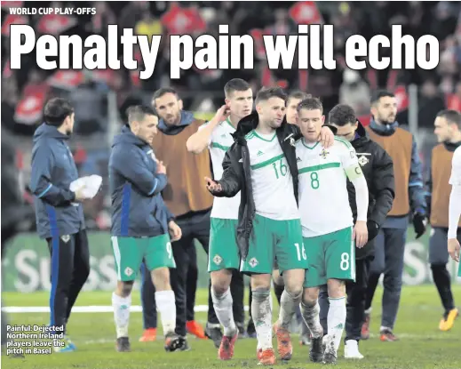  ??  ?? Painful: Dejected Northern Ireland players leave the pitch in Basel