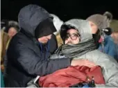  ?? RYAN REMIORZ/THE CANADIAN PRESS ?? Aymen Derbali, a victim who was shot seven times, is comforted during a vigil to commemorat­e the one-year anniversar­y of the Quebec City mosque shooting.