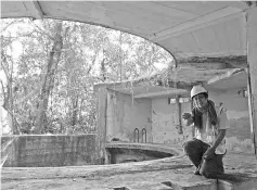  ??  ?? Lim briefing reporters at a colonial-era gun emplacemen­t tower built by the British in the 1930s on Pulau Ubin, a small island in eastern Singapore. — AFP photo