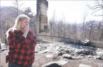  ?? Adam Beam/Associated Press ?? Tammy Sherrod views the remains of her home Friday in the Roaring Fork neighborho­od of Gatlinburg, Tenn.