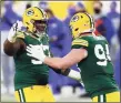  ?? Matt Ludtke / Associated Press ?? The Green Bay Packers’ Kenny Clark, left, is congratula­ted by Preston Smith after sacking Los Angeles Rams quarterbac­k Jared Goff during the second half of an NFL divisional playoff game Saturday in Green Bay.