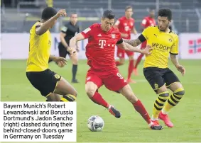  ??  ?? Bayern Munich’s Robert Lewandowsk­i and Borussia Dortmund’s Jadon Sancho (right) clashed during their behind-closed-doors game in Germany on Tuesday