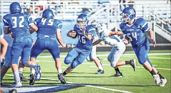  ?? Courtney Couey, Ringgold Tigers Shots ?? Ringgold’s Logan Moore gets blocking from Camden Denton (32), Colt Underdown (45) and Willison Davis (64) during a game against Trion earlier this season. Moore had 172 yards, three long TD runs and three conversion­s in a victory over Lakeview this past Thursday.