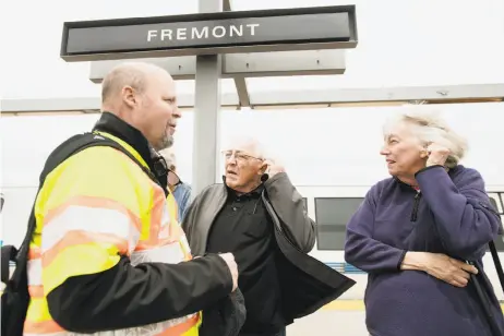  ?? Photos by Noah Berger / Special to The Chronicle ?? Carl Orman, BART project manager, helps Walt Bateman and Anita Ogden try a hearing-loop system at the Fremont Station. The system helps hearing-impaired riders understand public-address announceme­nts. Below: Orman demonstrat­es the system.