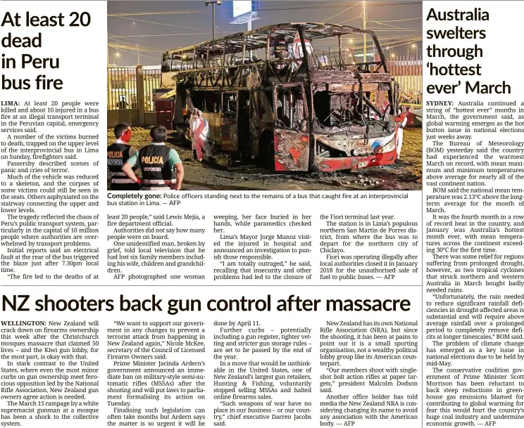  ??  ?? Completely gone: Police officers standing next to the remains of a bus that caught fire at an interprovi­ncial bus station in Lima. — AFP