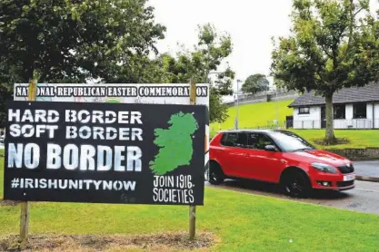  ?? File/reuters ?? A car drives past a sign saying ‘No Border, Hard border, soft border, no border’ in Londonderr­y, Northern Ireland, on August 16, 2017.