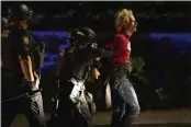  ?? PAULA BRONSTEIN — THE ASSOCIATED PRESS ?? Police make arrests on the scene of protests at a police precinct in Portland, Ore., on Aug. 302020.