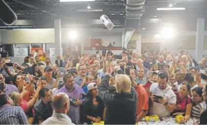  ?? Mandel Ngan, AFP/Getty Images ?? President Donald Trump, taking part in the distributi­on of food and supplies in Guaynabo, Puerto Rico, tosses paper towels to residents at Calvary Chapel on Thursday.