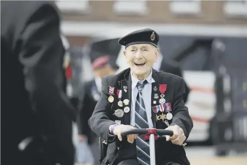  ??  ?? Veterans arrive for a D-day event in Portsmouth. Below right: US soldiers with D-day veteran Leonard Jindra, 98