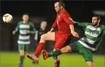  ??  ?? Keith O’Callaghan, Skerries and Des McKeown, Rock Celtic compete for possession.