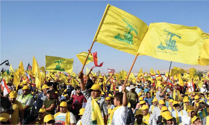  ?? (Reuters) ?? SUPPORTERS OF Hezbollah leader Sayyed Hassan Nasrallah display Hezbollah and Lebanese flags in Lebanon’s Bekaa valley.