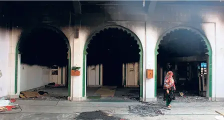  ??  ?? A MOSQUE SET
on fire by rioters in Mustafabad, Delhi on February 27.