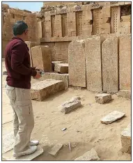  ?? The Associated Press/JON GAMBRELL ?? A Yemen official explores the Awwam Temple in Yemen.