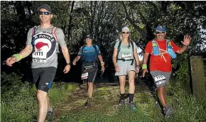  ?? GLENN JEFFREY/STUFF ?? Kat Lawrence (second from left), with Hingston Hotrod team members (from left) Kris de Lacy, Theresa Fisk and Virgil Clare, took painkiller­s to finish the 100km section after breaking her ankle four weeks ago while training for the event.