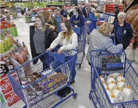  ?? BILL LACKEY / STAFF ?? Operation Thanksgivi­ng volunteers, including Clark State College criminal justice students, collect food at Meijer, Tuesday.