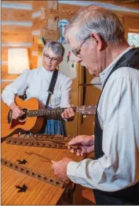  ?? WILLIAM HARVEY/RIVER VALLEY & OZARK EDITION ?? Donna and David Peterson of Greenbrier will present the program at the Faulkner County Historical Society meeting at 6 p.m. March 8 at the Faulkner County Library, 1900 Tyler St. in Conway. With Donna on guitar and David on hammered dulcimer, they demonstrat­e a traditiona­l tune, “Back Up and Push,” in their music room in Greenbrier. David said the tune is also known as “Rubber Dolly.”