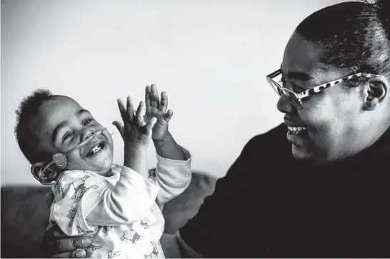  ?? BUTCH DILL/AP PHOTOS ?? Curtis Means plays with his mother, Michelle Butler, at their home in Eutaw, Alabama. The toddler stayed in the newborn intensive care unit for nine months after his birth.