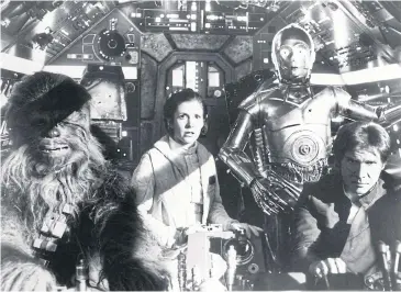  ??  ?? A scene from the 1980 film The Empire Strikes Back with, from left, Peter Mayhew as Chewbacca, Carrie Fisher as Princess Leia, Anthony Daniels as C-3PO and Harrison Ford as Han Solo.