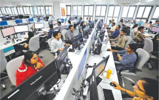  ?? Reuters ?? ↑ Employees work on their terminals inside the office of a local accounting firm in Ahmedabad, India.