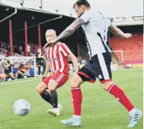  ??  ?? Grimsby clear under pressure from Dylan McGeouch.