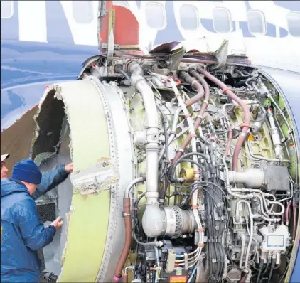  ?? Picture / AP ?? Investigat­ors examine the engine of the Southwest Airlines plane that made an emergency landing.