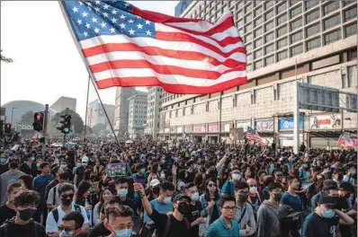  ?? (AFP) ?? Tens of thousands of protesters take part in a march from the Tsim Sha Tsui district to Hung Hom, demanding the government make concession­s after pro-democracy candidates won a landslide victory, in Hong Kong, on Sunday.