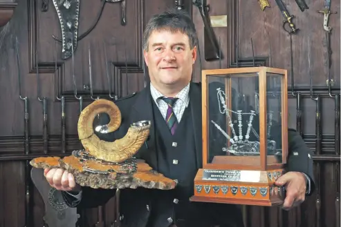  ??  ?? PIPE CHAMPION: Angus MacColl with his fourth Glenfiddic­h Piping Championsh­ip win; he was previously crowned champion at the event in 1995, 2006 and 2010