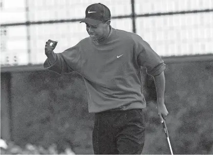  ?? PORTER BINKS/USA TODAY NETWORK ?? Tiger Woods gives his signature fist pump on the 18th green after winning the 1997 Masters by 12 strokes at Augusta National Golf Club.