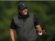  ?? ALASTAIR GRANT — THE ASSOCIATED PRESS ?? Phil Mickelson reacts to the crowd during the final round of the inaugural LIV Golf Invitation­al on June 11 in St Albans, England.