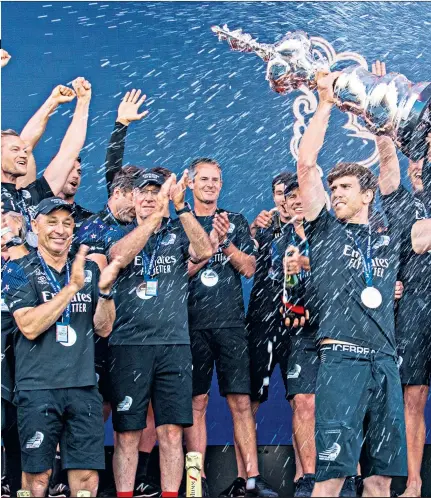  ??  ?? Glory day: Team New Zealand helmsman Peter Burling holds the America’s Cup trophy aloft after beating Italy’s Luna Rossa; (left and right) celebratin­g winning race 10 on Auckland’s Waitemata Harbour to seal victory