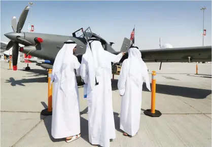  ??  ?? DUBAI: Men look at an US-made Archangel intelligen­ce, surveillan­ce and reconnaiss­ance plane displayed at the Dubai Airshow yesterday in the Gulf Emirate. — AFP