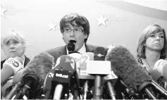  ??  ?? Puigdemont, flanked by former Catalan ministers Clara Ponsati (left) and Meritxell Borras, at a news conference at the Press Club Brussels Europe in Brussels, Belgium. — Reuters photo