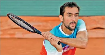  ?? — AP ?? Marin Cilic of Croatia returns to Russia’s Daniil Medvedev during their French Open fourth round match at Roland Garros Stadium on Monday.