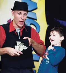  ?? Scott Mullin / For Hearst Connecticu­t Media ?? Magician Danny Diamond uses 5-year-old Lucas Castelhano as his assistant for a trick at a Hanukkah event hosted by the Early Childhood Center of Congregati­on Shir Shalom in Ridgefield in 2017.