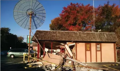  ?? Photo by Russ Olivo ?? Later on Wednesday morning, the van had been removed from the scene and some work was done to shore up the damaged portion of the building. The station’s satellite dish also escaped serious damage, and the station was broadcasti­ng as usual.