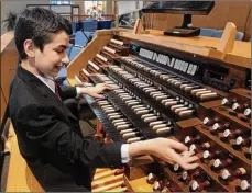  ?? MIKE CARDEW / BEACON JOURNAL ?? Daniel Colaner, 12 plays the organ at Saint Sebastian Catholic Church in Akron. Daniel will play Chopin’s Fantasie Impromptu, Opus 66 on piano at Carnegie Hall in New York City.