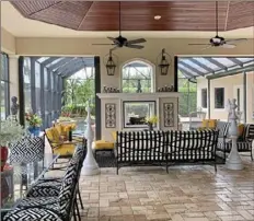 ?? Patricia Sheridan/Post-Gazette photos ?? A two-way outdoor fireplace separates the screened-in lanai from the pool in Ellaine and Rick Rosen's home in Naples, Fla.