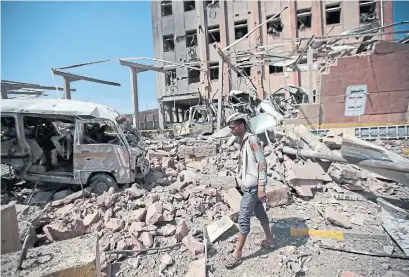  ?? HANI MOHAMMED THE ASSOCIATED PRESS FILE PHOTO ?? A man inspects rubble after a Saudi-led coalition airstrike in Sanaa, Yemen, where war has raged for more than five years.