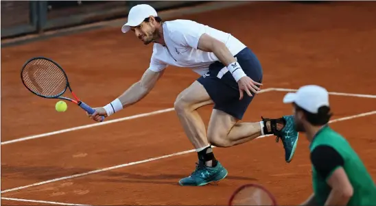  ??  ?? Andy Murray returns a forehand during he and Liam Broady’s victory in Rome over Max Purcell and Luke Saville last night