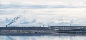  ??  ?? A Suncor tailings pond north of Fort McMurray. Oil companies are required to return the lands they develop to a natural state.