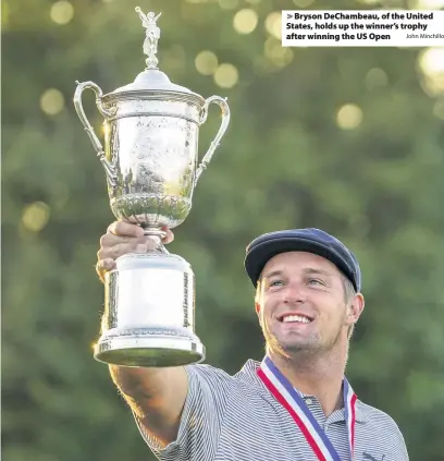  ?? John Minchillo ?? > Bryson DeChambeau, of the United States, holds up the winner’s trophy after winning the US Open